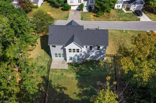 an aerial view of a house with a yard