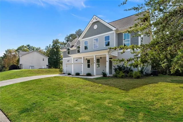 a view of a house with a yard and garage