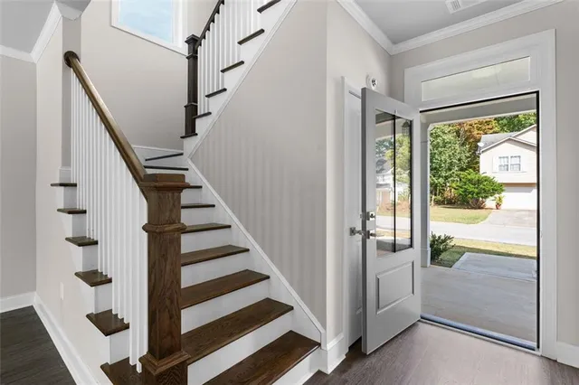 a view of entryway with wooden floor and windows