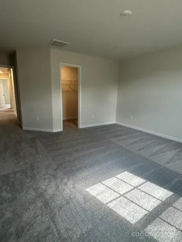 an empty room with windows and entrance