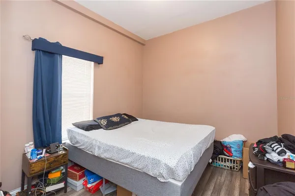 a bedroom with a bed and a dresser in it