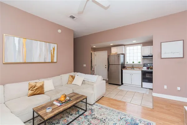 a living room with furniture and kitchen view