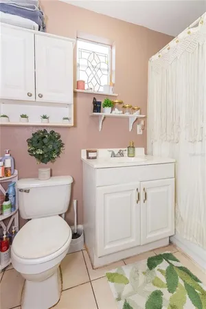 a bathroom with a sink a toilet and a window