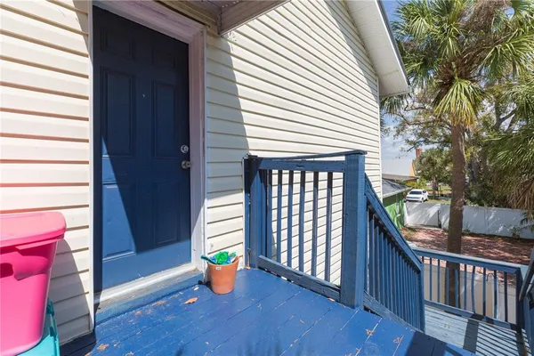 a view of a porch with wooden floor and fence and a wooden deck