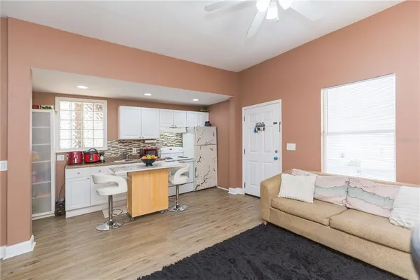 a living room with kitchen island furniture and a wooden floor