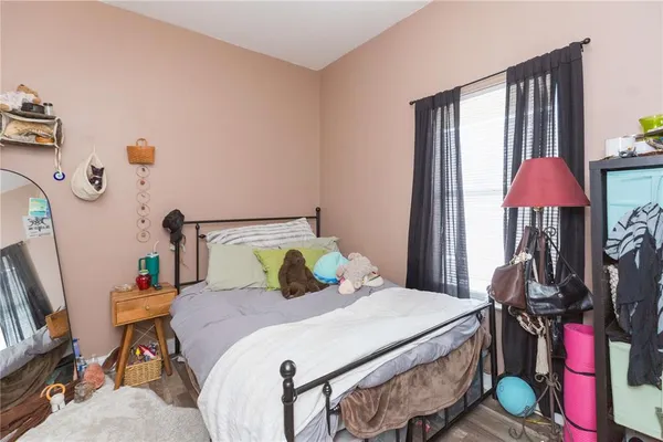 a bedroom with a bed and a chandelier