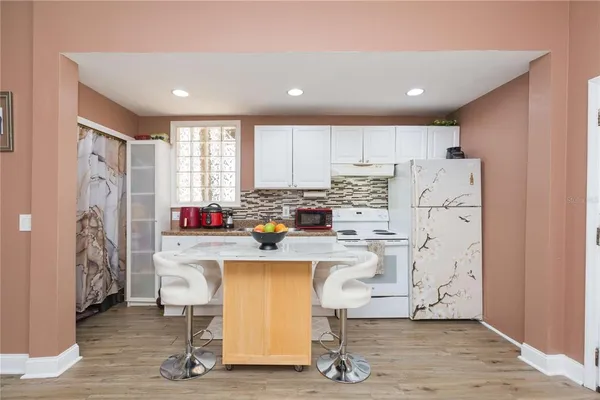 a kitchen with refrigerator and cabinets