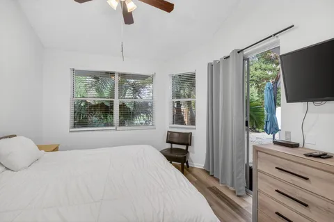 a bedroom with a bed and a flat tv screen