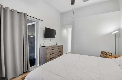 a bedroom with a bed and a flat screen tv