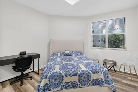 a bedroom with a bed and a window