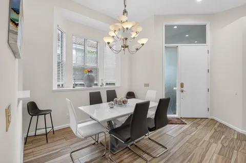 a view of a dining room with furniture and chandelier