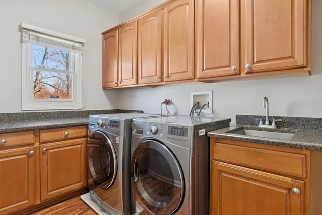 a utility room with sink dryer and washer