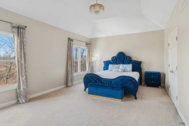 a spacious bedroom with a bed and a window