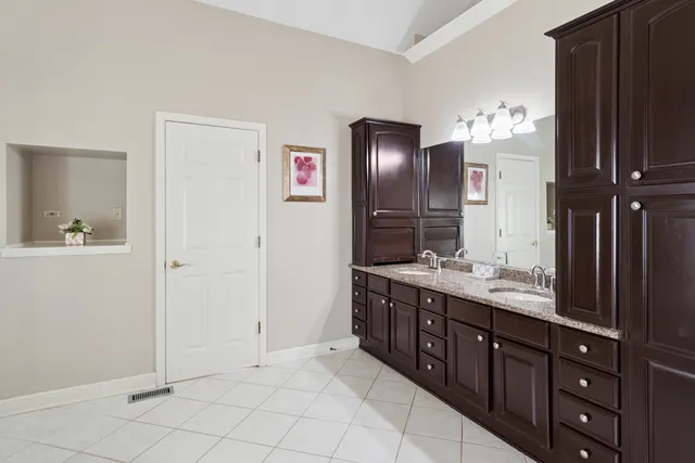 a spacious bathroom with a double vanity sink and a mirror