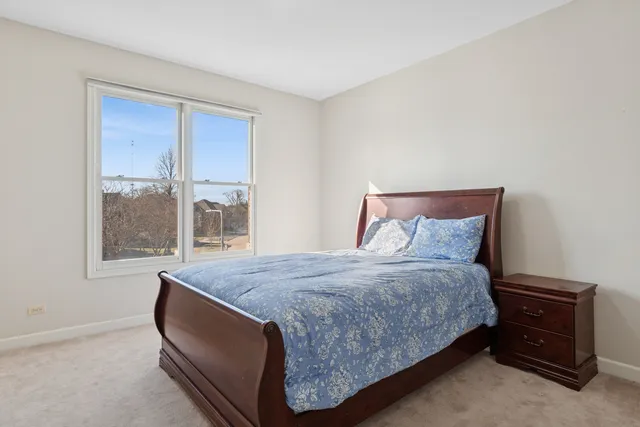 a bed sitting in a bedroom next to a window