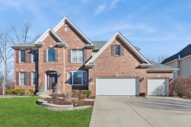 a front view of a house with a yard outdoor seating and garage