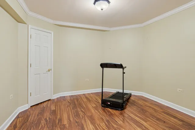 a view of a room with wooden floor and a window