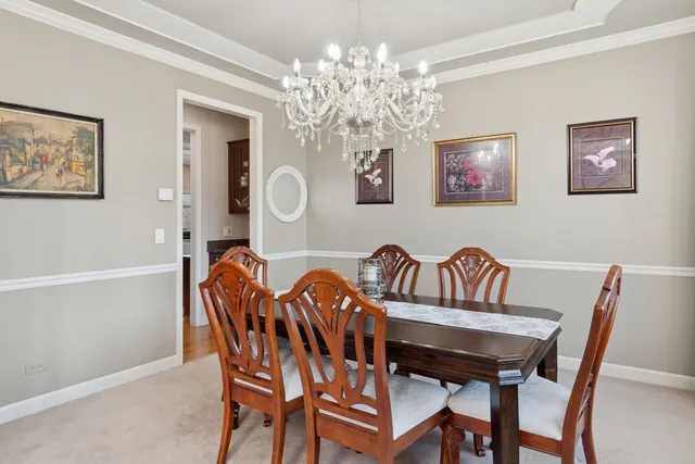 a view of a dining room with furniture and chandelier