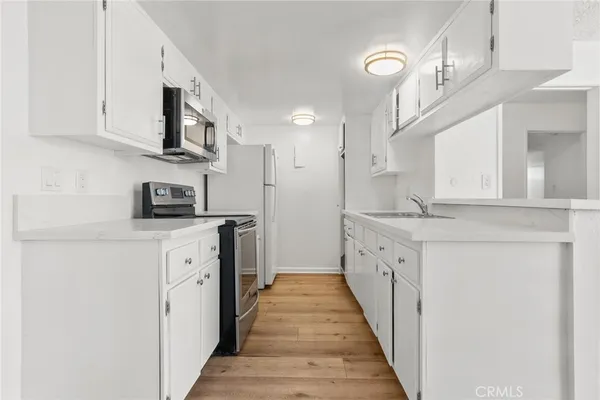 a kitchen with stainless steel appliances granite countertop lots of counter space and cabinets