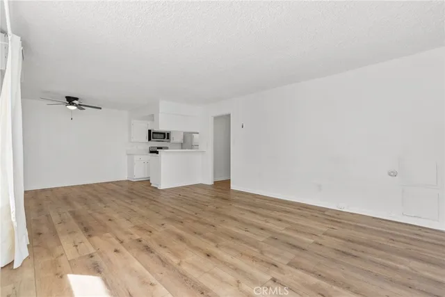 a kitchen with a refrigerator sink and cabinets