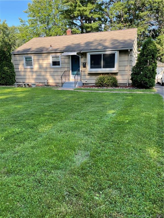 a front view of house with yard and outdoor seating