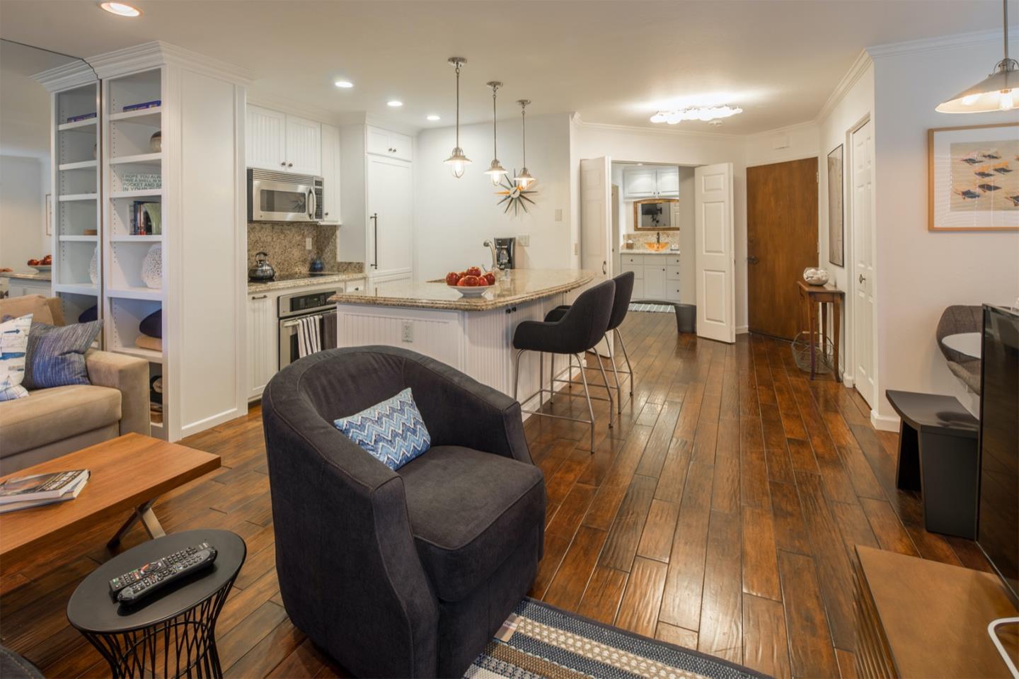a living room with furniture and a wooden floor