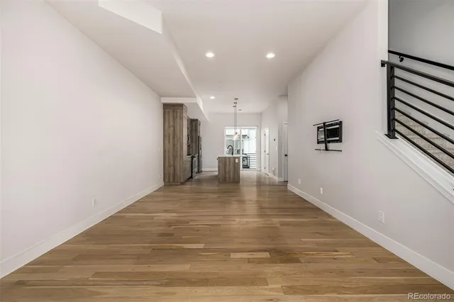 a view of empty room with wooden floor