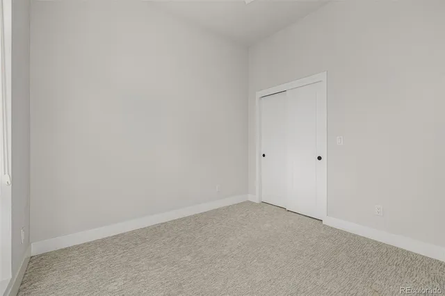 a bathroom with a granite countertop sink toilet a mirror and shower