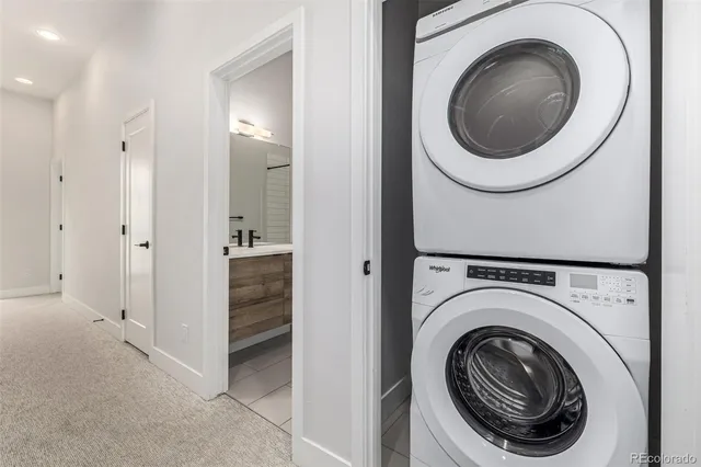 a roof deck with couches and wooden floor