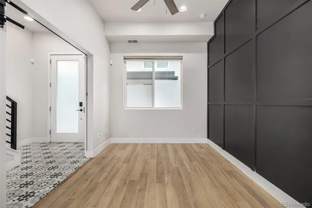a view of a hallway view with wooden floor and staircase