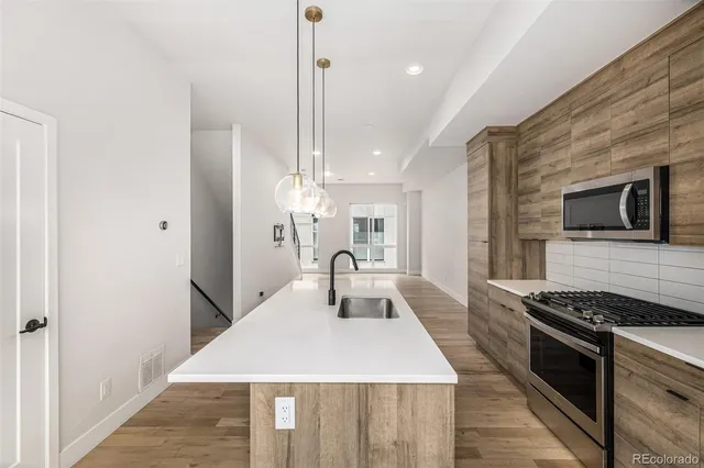 a kitchen with a table chairs and a chandelier