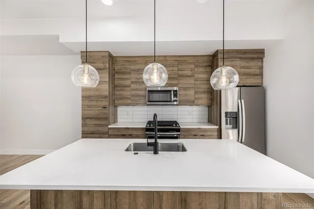 a stove top oven sitting inside of a kitchen