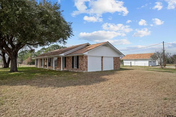 a front view of house with yard and trees