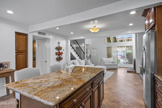 a kitchen with stainless steel appliances granite countertop a sink stove and microwave