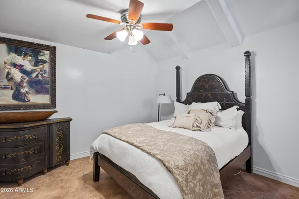 a bedroom with a bed and a ceiling fan