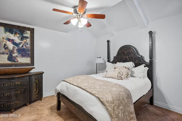a bedroom with a bed and a ceiling fan