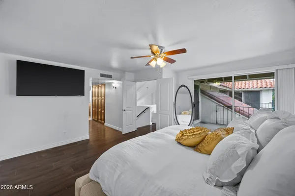 a bedroom with a bed and a chandelier