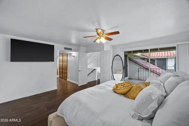 a bedroom with a bed and a chandelier