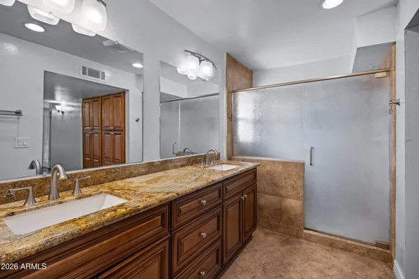 a bathroom with a granite countertop sink and a mirror