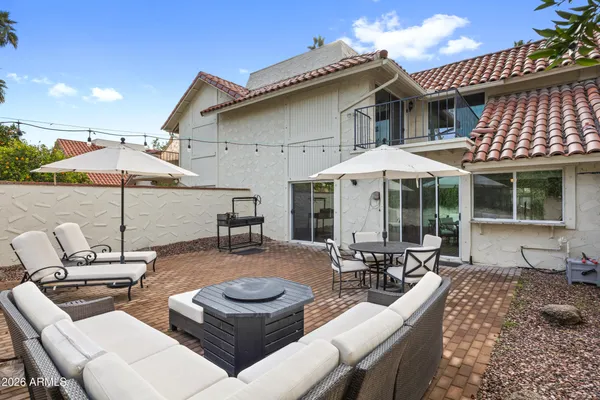 a patio with tables and chairs