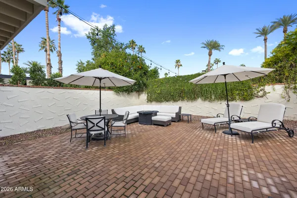 an outdoor space with patio and white umbrellas