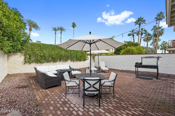 a view of a backyard with sitting area and furniture