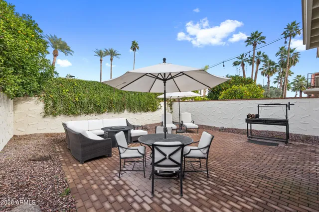 a view of a backyard with sitting area and furniture