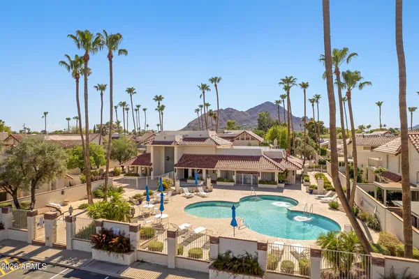 a view of a swimming pool with outdoor seating