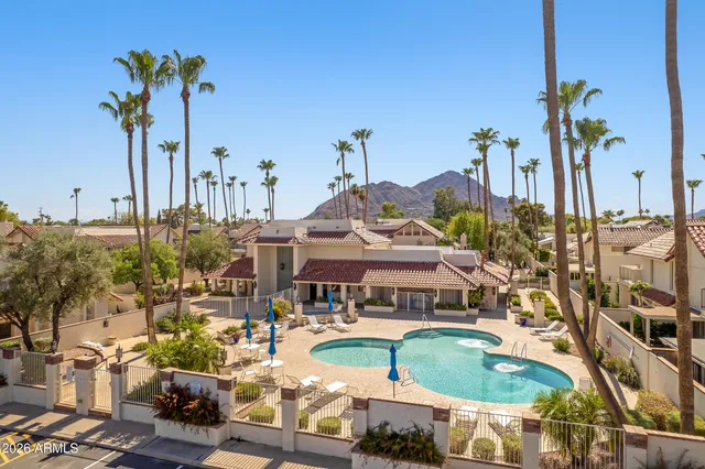 a view of a swimming pool with outdoor seating