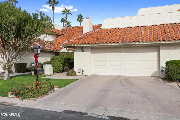 a front view of a house with a garden
