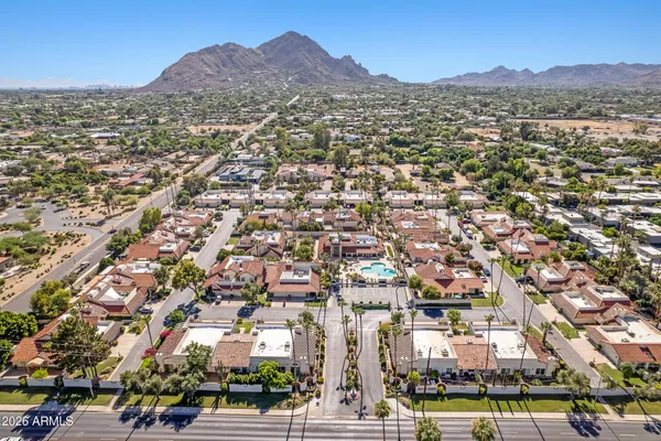 an aerial view of residential houses with a city view