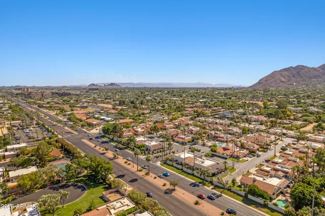 an aerial view of residential houses with city view