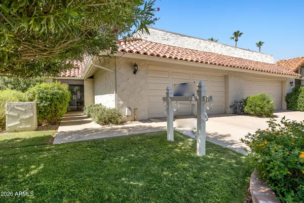 a front view of a house with garden