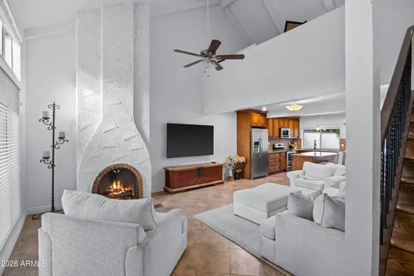 a living room with furniture a fireplace and a flat screen tv
